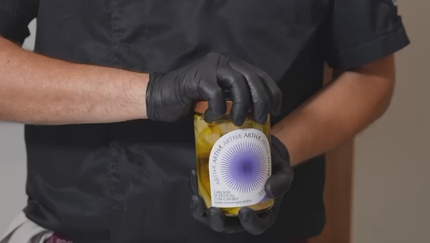 video che mostra l'impiattamento del carciofo con gambo da parte di uno chef con guanti neri